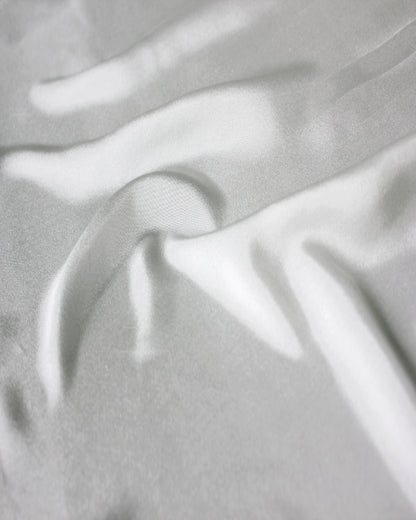 Close-up of white 12 momme silk Habotai showing its fine plain-weave surface and soft natural lustre.