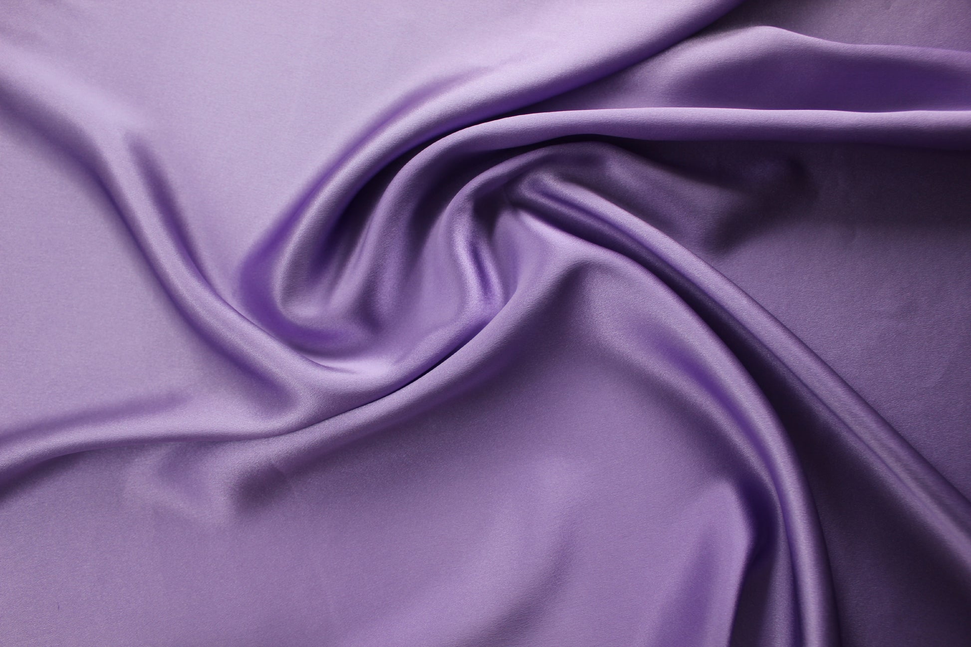 19 momme silk charmeuse in lavender purple showing medium body, clean folds and reflective satin highlights.