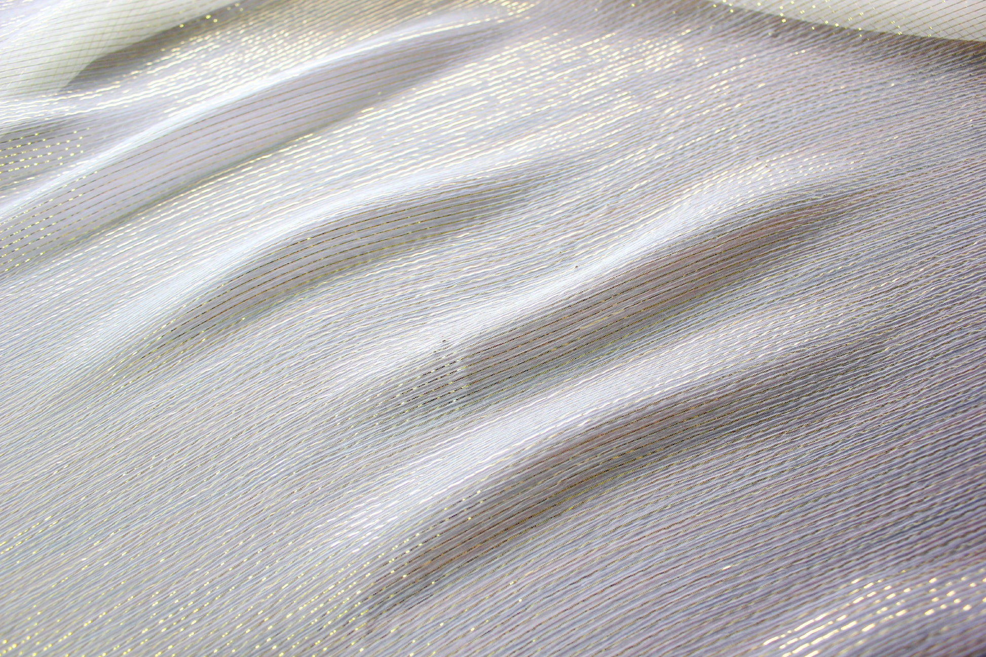 Detailed view of the fine longitudinal gold metallic stripe pattern on 5.5 momme silk Yoryu.