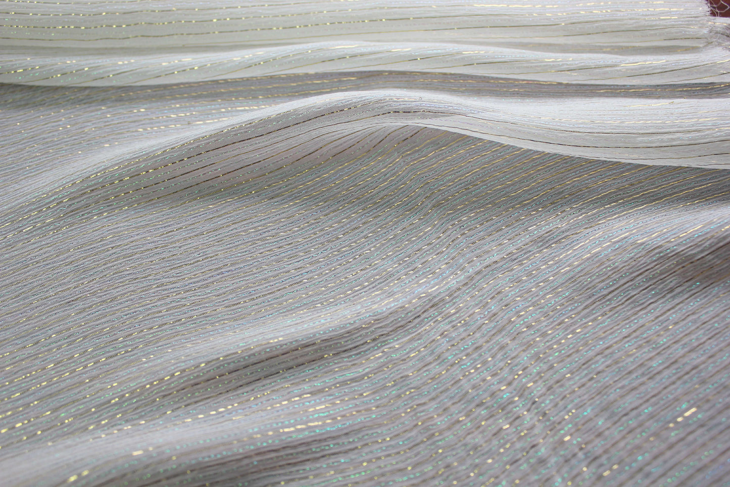MingSilk 6 momme mulberry silk Yoryu in bleached white with fine iridescent metallic stripes and fluid folds.