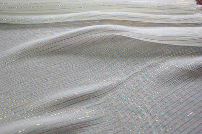 MingSilk 6 momme mulberry silk Yoryu in bleached white with fine iridescent metallic stripes and fluid folds.
