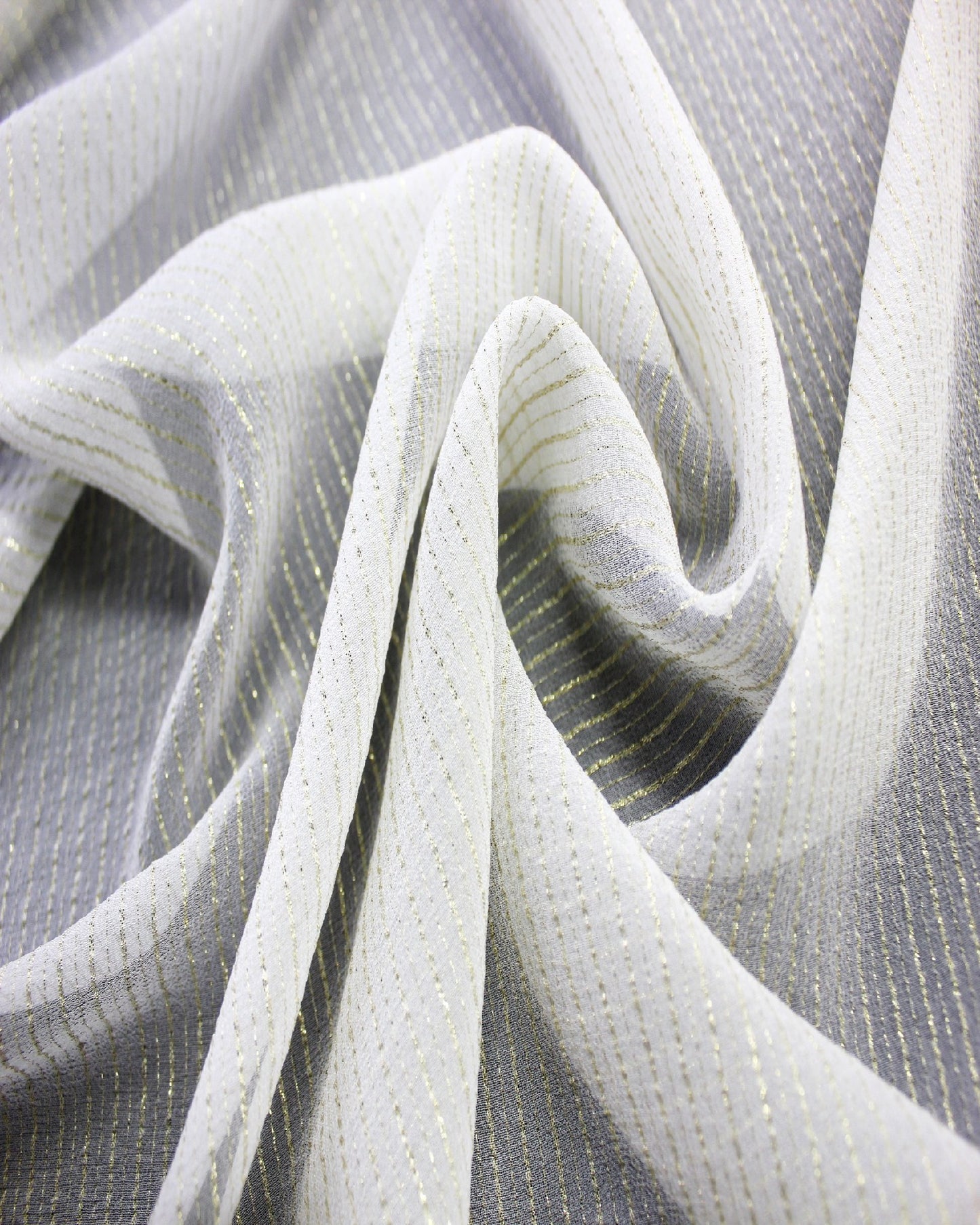 White gold-striped silk Yoryu arranged in flowing folds to show its lightweight hand, texture and graceful drape.