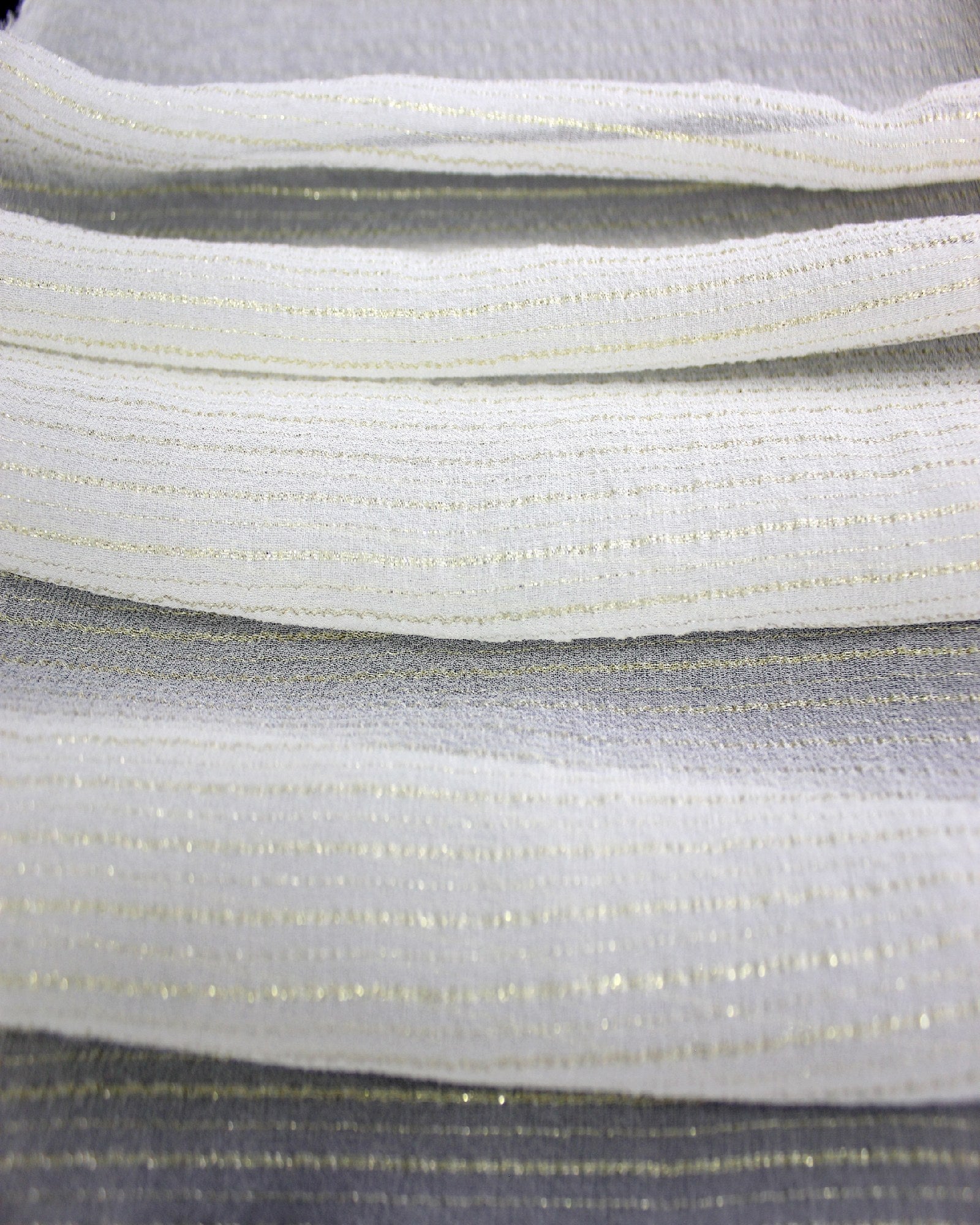 Layered white 9 momme silk Yoryu fabric showing gold metallic stripe spacing, lightweight body and layered opacity.