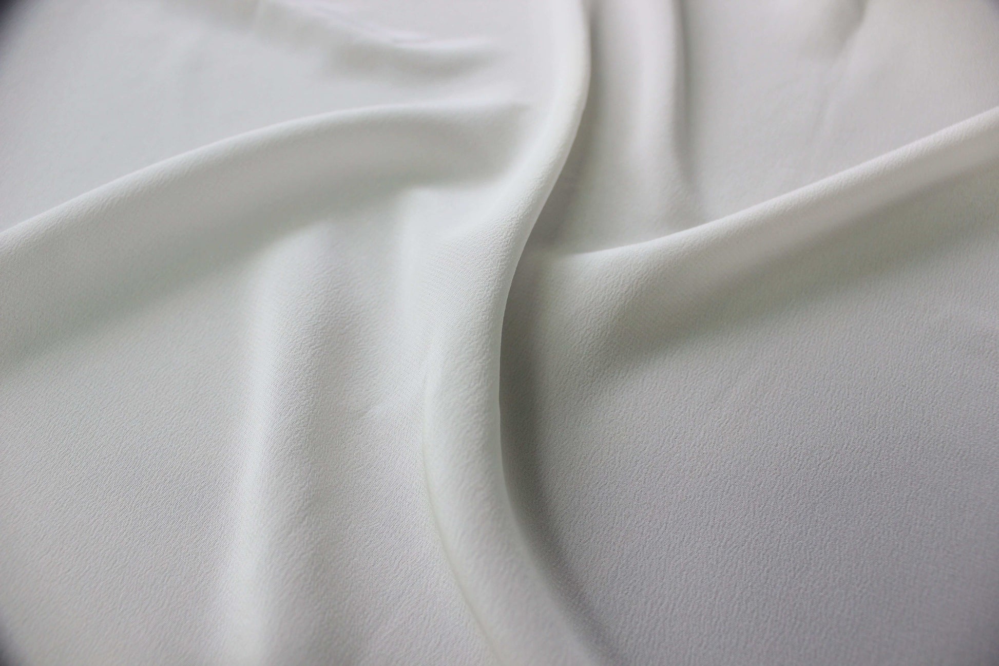 Detailed view of the subtle granular texture and smooth drape of MingSilk mulberry silk Crepe de Chine.