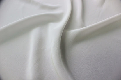 Detailed view of the subtle granular texture and smooth drape of MingSilk mulberry silk Crepe de Chine.