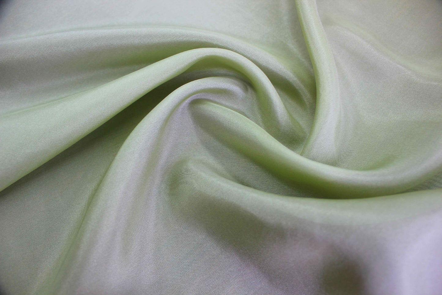Lightweight silk Habotai fabric showing smooth flowing drape and soft luster
