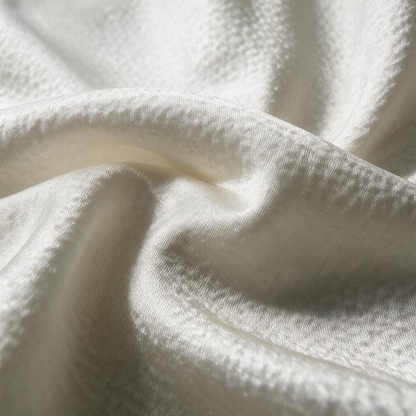 Pearlescent highlights moving across the fine textured surface of MingSilk mulberry silk pearl satin.