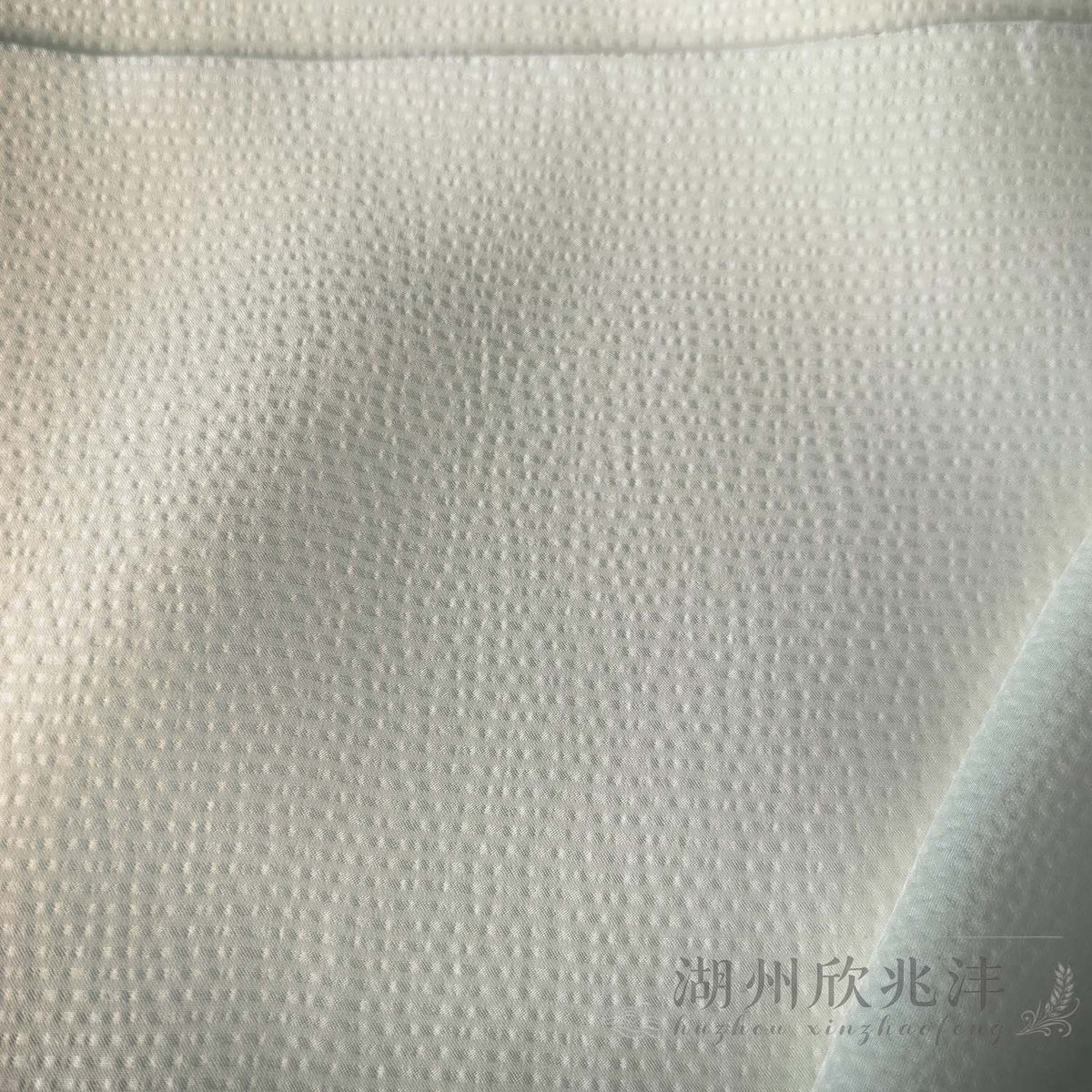 Close-up of the fine pearl-like textured surface on MingSilk 19 momme mulberry silk satin.