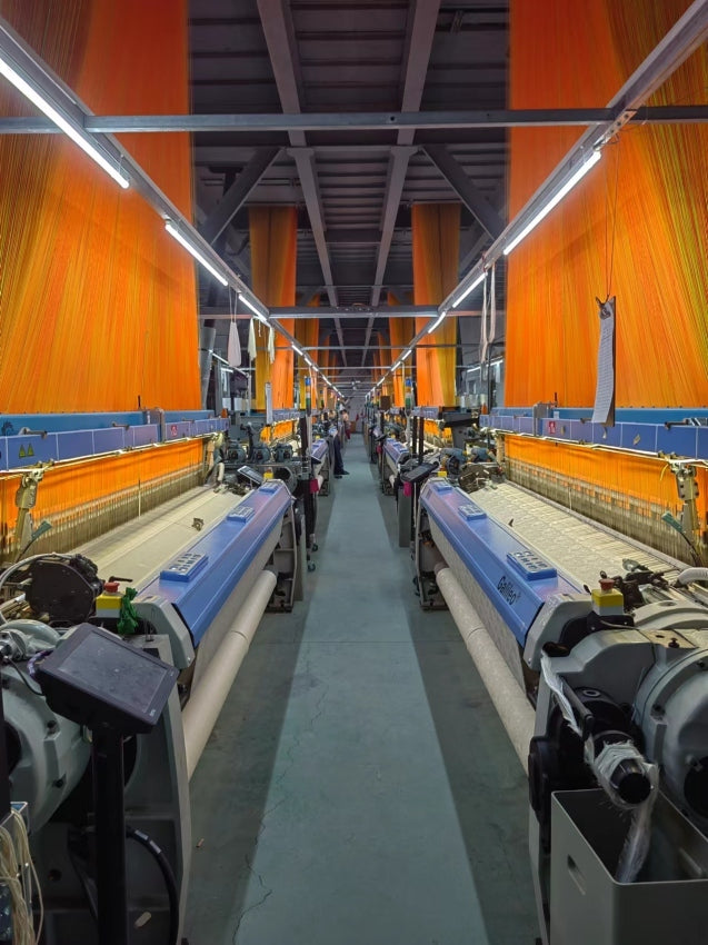 Silk weaving production hall with rows of looms
