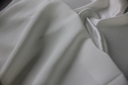MingSilk silk charmeuse showing contrasting smooth satin reflections and softly matte surface areas across the folds.