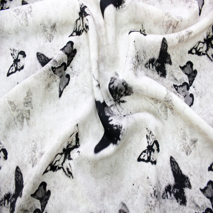 Folded lightweight silk viscose fabric swatch showing multi-layer butterfly pattern display