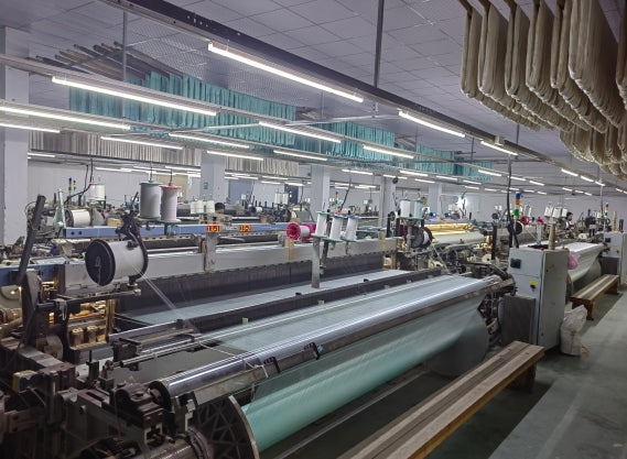 Weaving looms in operation at a silk production facility