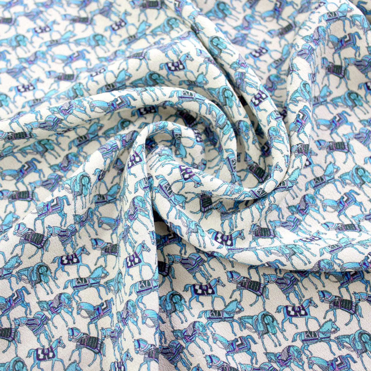 Horse motif silk crepe de chine fabric swirled to show lightweight flow